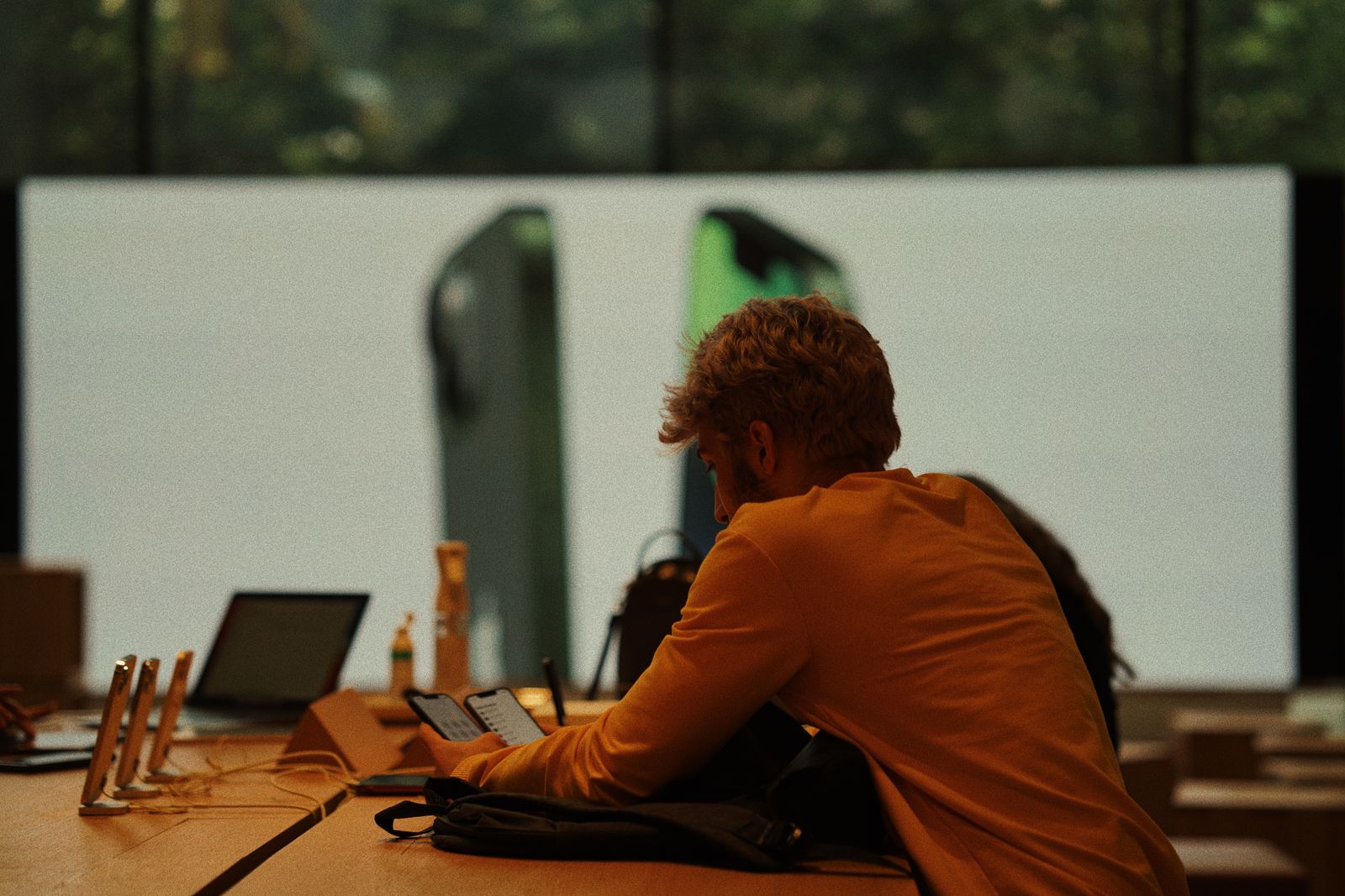 A customer examining smartphones in a gadget store